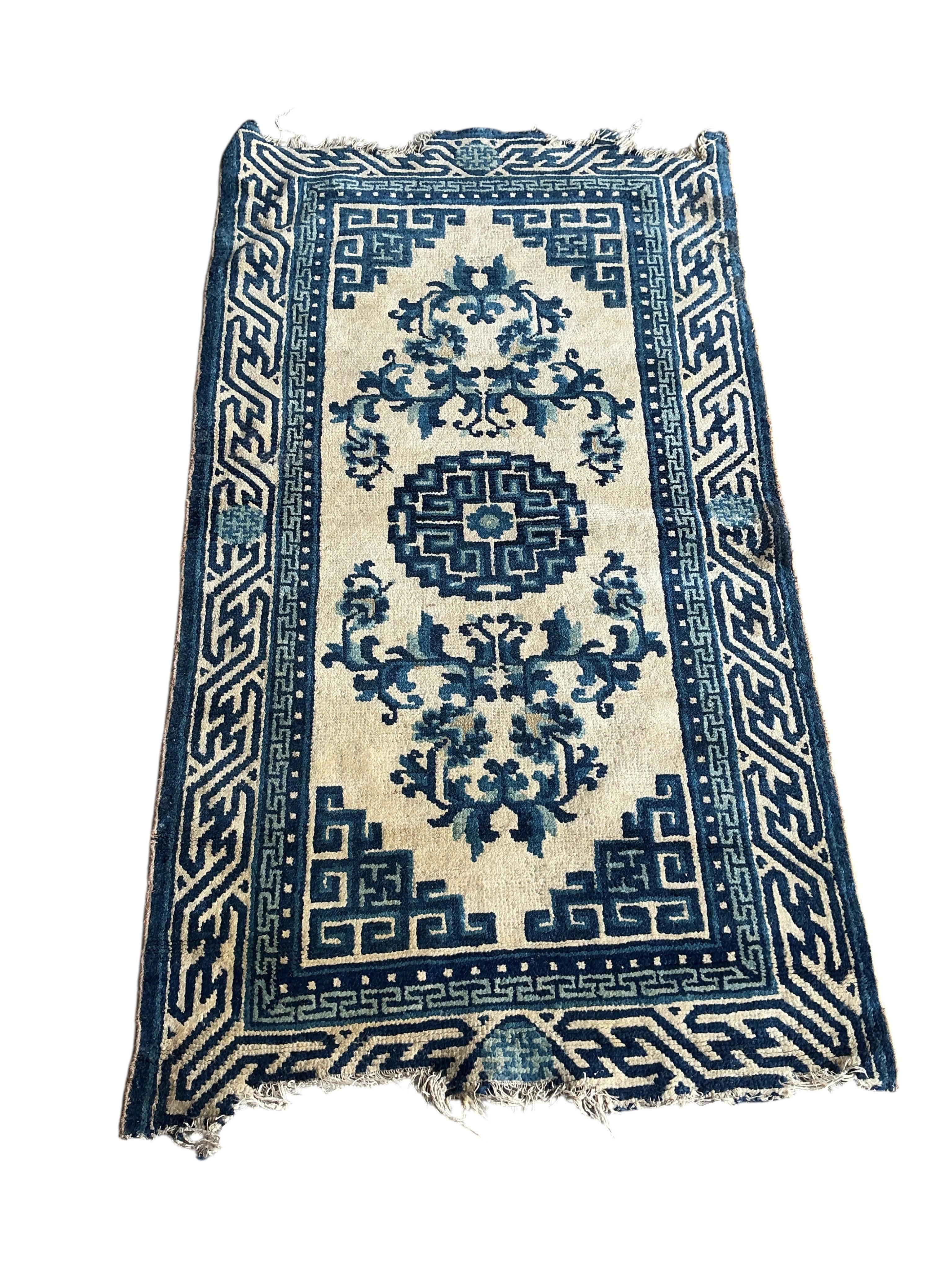 Two Sino-Tibetan ivory ground rugs, 19th century and two Tibetan ivory ground square mats, largest 120 x 66cm